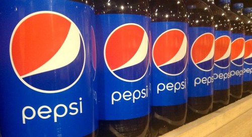 A row of Pepsi bottles with the iconic blue label and logo displayed prominently.