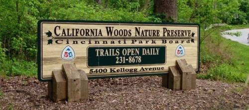 Sign for California Woods Nature Preserve in Cincinnati, featuring park board details and contact information.