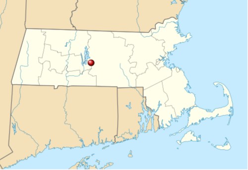 Map showing a location in central Massachusetts, marked with a red dot, surrounded by light-colored land and water.