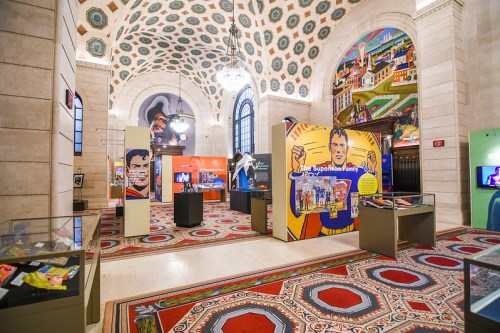Interior of a museum featuring colorful exhibits, murals, and decorative architecture.