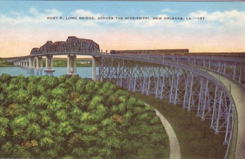 Postcard of the Huey P. Long Bridge over the Mississippi River, with a train crossing and lush greenery below.