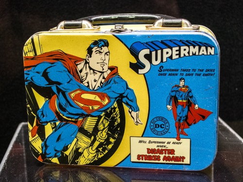A vintage Superman lunchbox featuring the superhero in action, with the text "Will Superman be ready when disaster strikes again?"