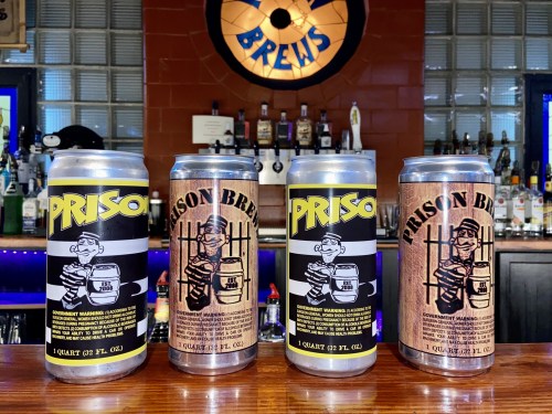 Four beer cans labeled "Prison Brew" on a bar, featuring cartoonish characters and distinct designs.