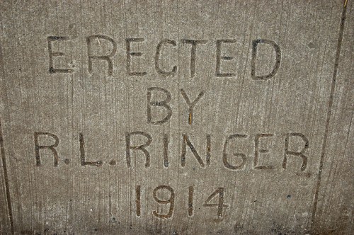 Engraved text on concrete reads: "Erected by R.L. Ringer 1914."