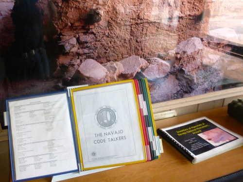 A display featuring documents about the Navajo Code Talkers and a book on Native American history.