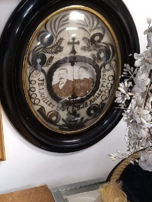 Framed vintage photo of a couple, dated June 28, 1900, surrounded by decorative floral elements.