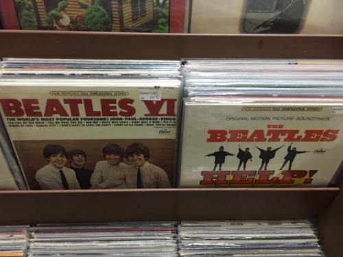 Two Beatles vinyl records displayed in a rack: "Beatles VI" and "Help!" soundtrack.