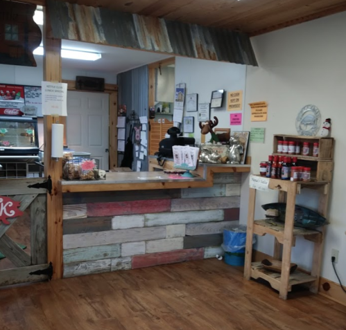 Cozy rustic shop interior with a wooden counter, shelves, and a welcoming atmosphere.