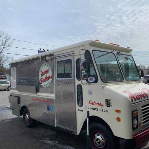 A food truck with a white exterior and silver accents, featuring the name "House Brothers" and contact information.