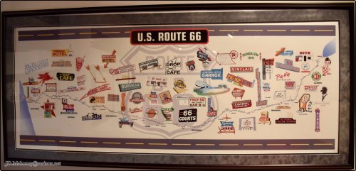 A colorful map of U.S. Route 66 featuring vintage signs for motels, cafes, and attractions along the highway.
