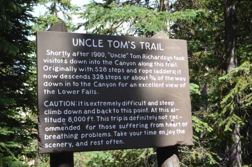 Sign for Uncle Tom's Trail, detailing its history and cautioning visitors about the steep descent to the canyon.