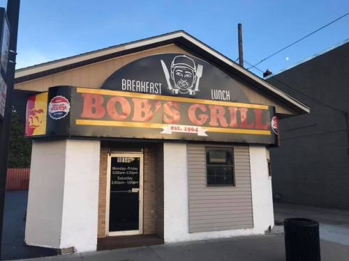 Exterior of Bob's Grill, a restaurant established in 1964, featuring a sign for breakfast and lunch.