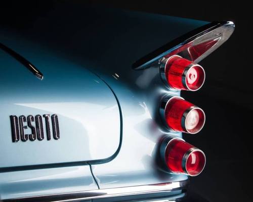Close-up of a vintage DeSoto car's rear, featuring distinctive tail lights and sleek design.