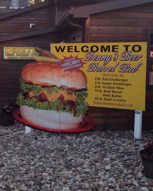 Sign for Denny's Beer Barrel Pub in Clearfield, PA, featuring a giant burger and details about burger challenges.