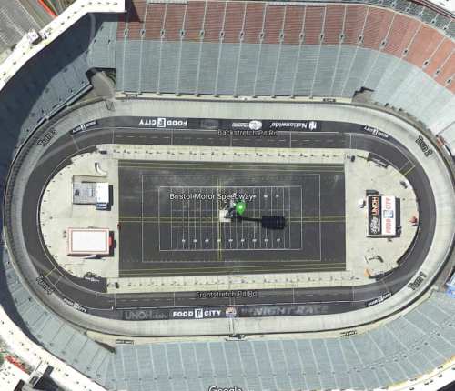 Aerial view of Bristol Motor Speedway, showcasing the oval track and surrounding grandstands.