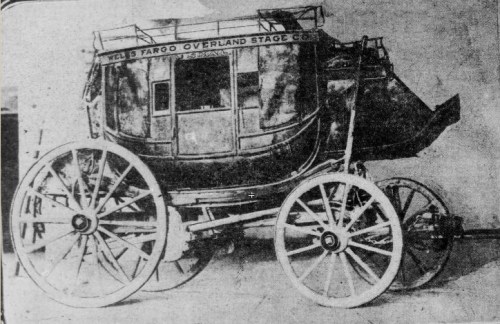 Historic stagecoach from Wells, Fargo & Co., featuring large wooden wheels and a detailed carriage design.