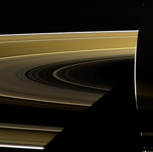 A close-up view of Saturn's rings, showcasing their intricate patterns and colors against a dark background.