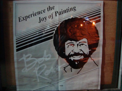 Poster featuring Bob Ross with the text "Experience the Joy of Painting" and a stylized illustration of his face.