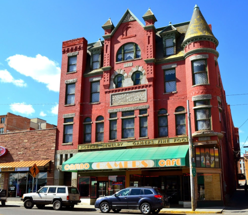 Historic red brick building with ornate architecture, featuring "Gamers Fine Food" and "Casino Gamers Café" signage.