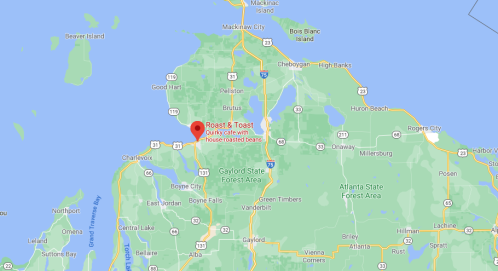Map showing northern Michigan with a marker for "Roast & Toast," a quirky café known for house-roasted beans.