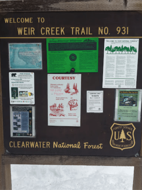 Signboard for Weir Creek Trail No. 931 in Clearwater National Forest, featuring various informational notices and guidelines.
