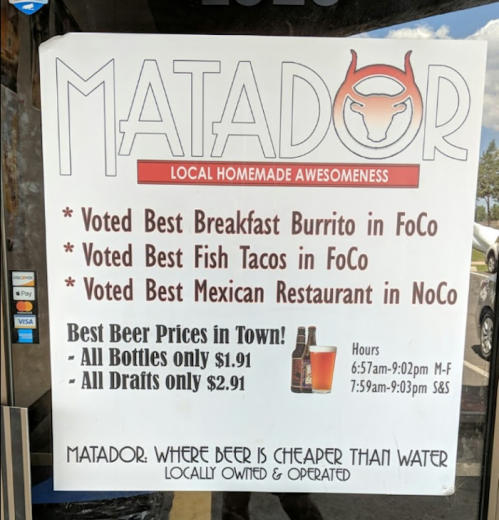 Sign for Matador, highlighting awards for food and best beer prices, with hours and special offers listed.