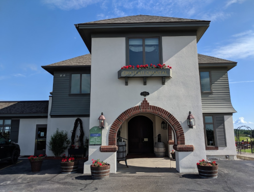 A charming winery building with a sign reading "Chateau Chantal," featuring flower boxes and a welcoming entrance.
