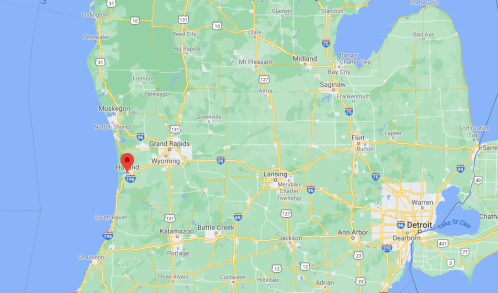 Map of Michigan highlighting the area around Holland, near Lake Michigan, with nearby cities and highways.