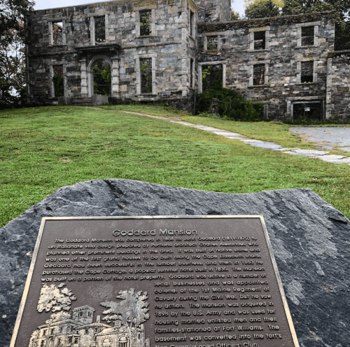 Plaque about Goddard Mansion, a historic site with ruins and a stone marker detailing its history and significance.