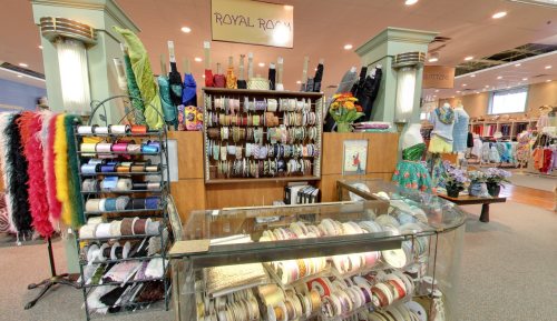 A craft store display featuring various ribbons, trims, and fabrics, with a sign reading "Royal Room" above.