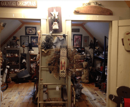 A cozy room decorated for Christmas, featuring rustic decor, wreaths, and festive ornaments.