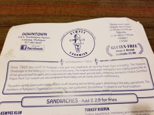 Menu from Kewpee Sandwiches in Lansing, Michigan, highlighting their history and offerings since 1923.