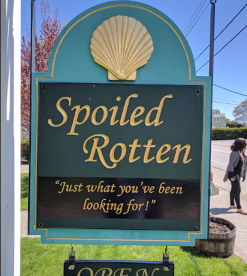 Sign for "Spoiled Rotten" with a shell design, featuring the tagline "Just what you've been looking for!"