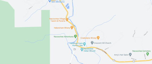 Map showing Nacoochee Village with nearby attractions like wineries, a historic site, and local businesses.