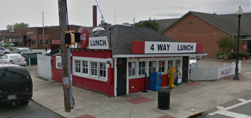 A small diner named "4 Way Lunch" with a red and white exterior, located at a street corner.