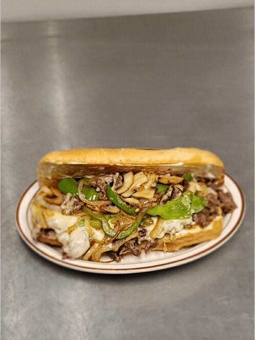 A hearty sandwich filled with beef, sautéed onions, and green peppers, served on a toasted hoagie roll.