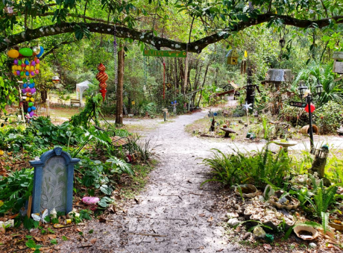 A winding path through a lush garden, adorned with colorful decorations and whimsical sculptures.