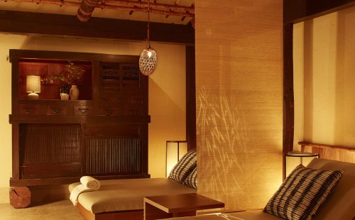A serene interior with wooden furniture, soft lighting, and decorative elements, creating a calming atmosphere.