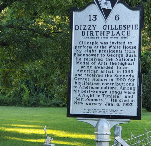 Historical marker about Dizzy Gillespie's birthplace, detailing his achievements and contributions to music and culture.
