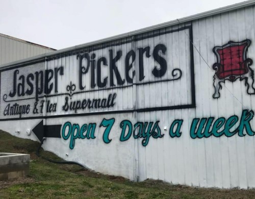 Sign for Jasper Pickers Antique & Flea Supermall, featuring decorative lettering and "Open 7 Days a Week" message.