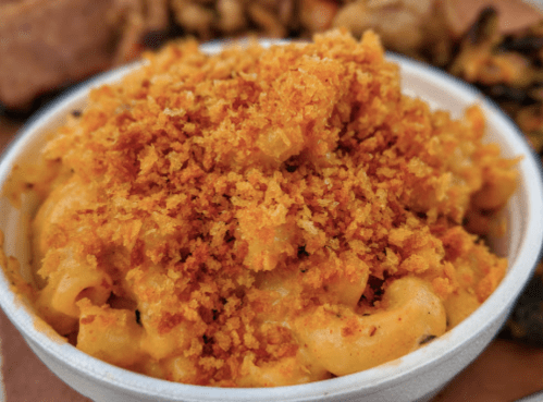A bowl of creamy macaroni and cheese topped with golden, crispy breadcrumbs.