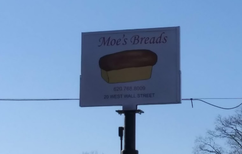 Sign for "Moe's Breads" featuring a loaf of bread, with contact number and address: 20 West Wall Street.