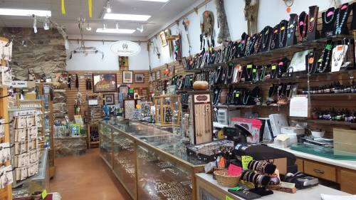A jewelry store interior featuring displays of necklaces, bracelets, and various accessories on shelves and counters.