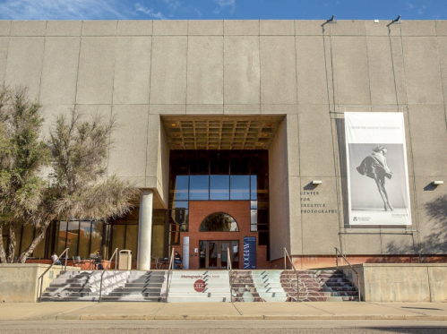 Exterior view of the Center for Creative Photography, featuring a modern entrance and large banner.