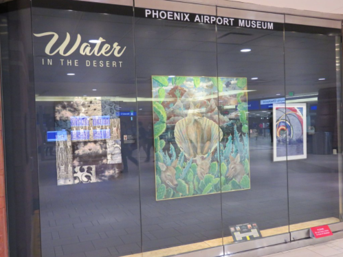 Exhibit titled "Water in the Desert" at Phoenix Airport Museum, featuring colorful artwork and informative displays.