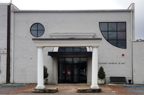 Front view of the Gadsden Museum of Art, featuring a modern design with large windows and a columned entrance.
