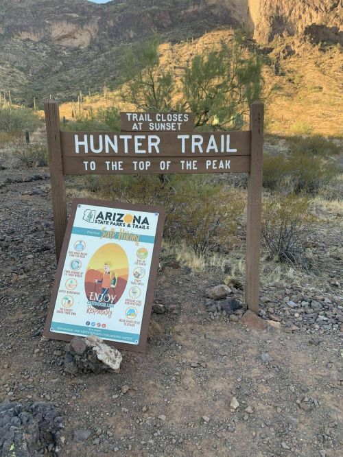 Sign for Hunter Trail, indicating it closes at sunset, with information about the trail and nearby attractions.