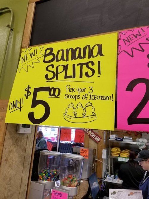 Bright yellow sign advertising "Banana Splits!" for $5, with a note to pick three scoops of ice cream.