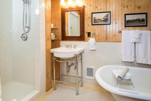 Cozy bathroom featuring a shower, vintage decor, a freestanding tub, and wooden accents.