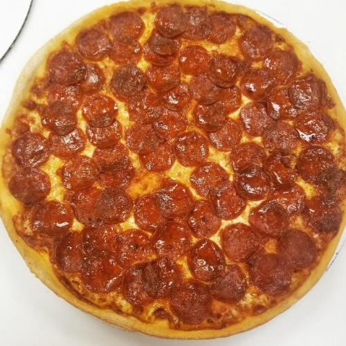 A freshly baked pepperoni pizza with a golden crust and a generous layer of pepperoni slices on top.